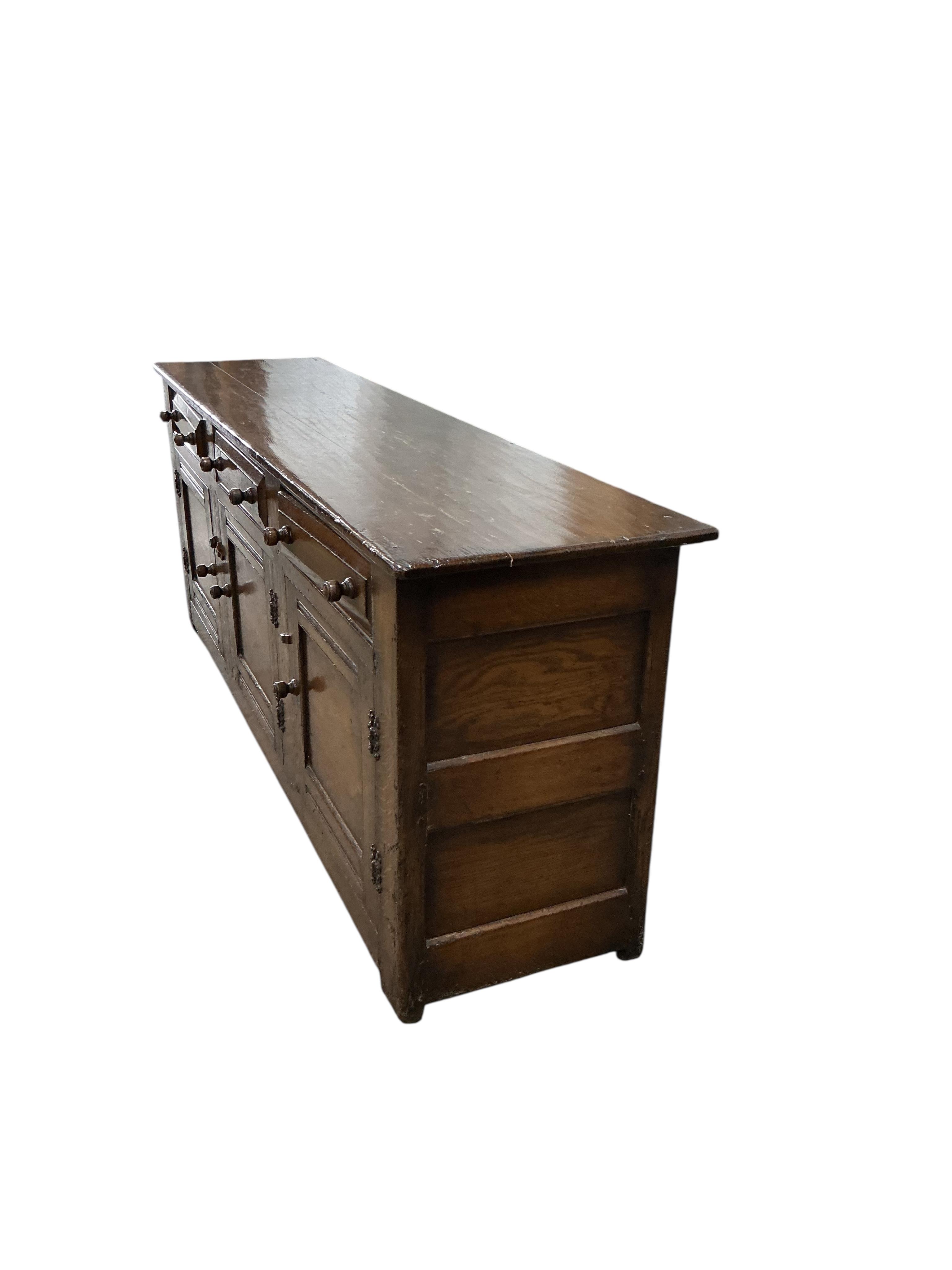 A reproduction 18th century style oak low dresser, width 198cm, depth 48cm, height 76cm